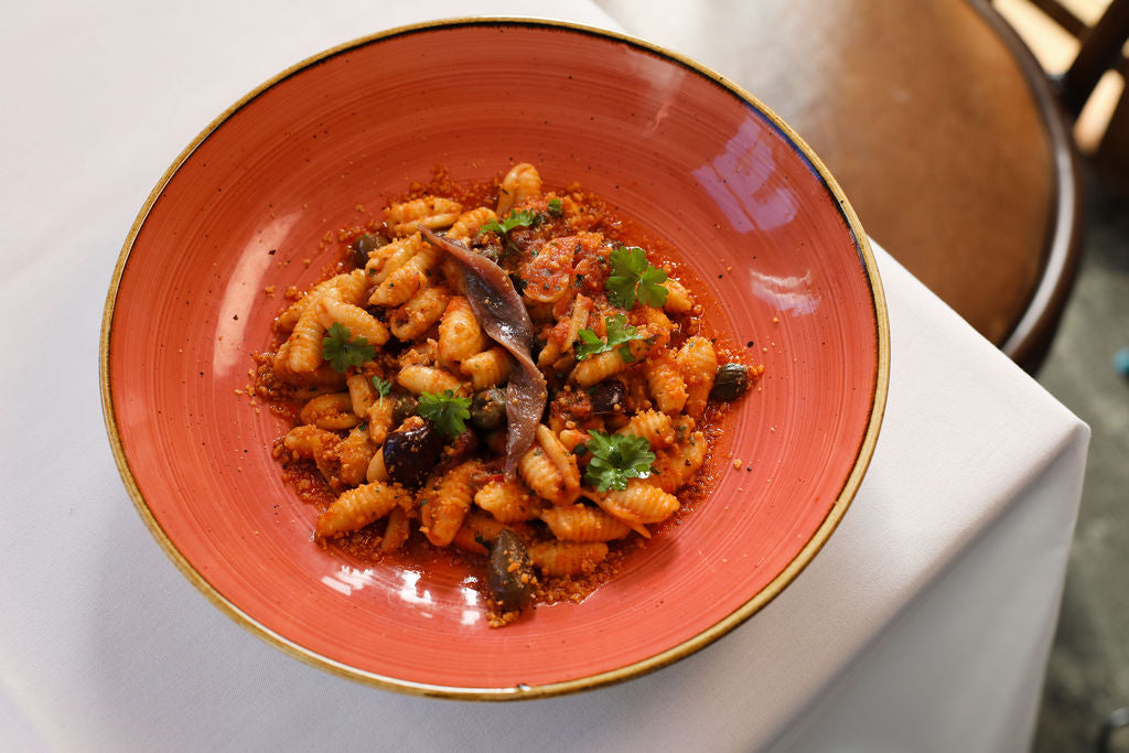 Cavatelli alla Puttanesca, garlic, tomato, olives, capers, anchovy, parsley, chilli crumbs (PS)