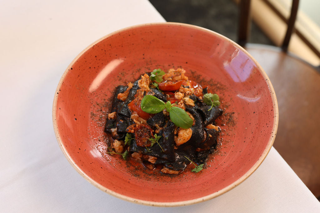 Black Squid Ink Tagliolini, chilli, garlic, Crab ragout, tomato, capers dust, parsley