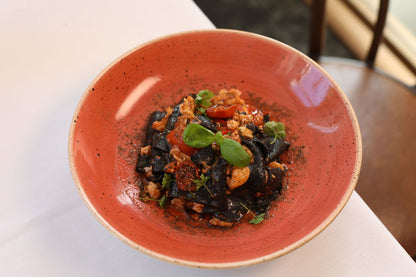 Black Squid Ink Tagliolini, chilli, garlic, Crab ragout, tomato, capers dust, parsley
