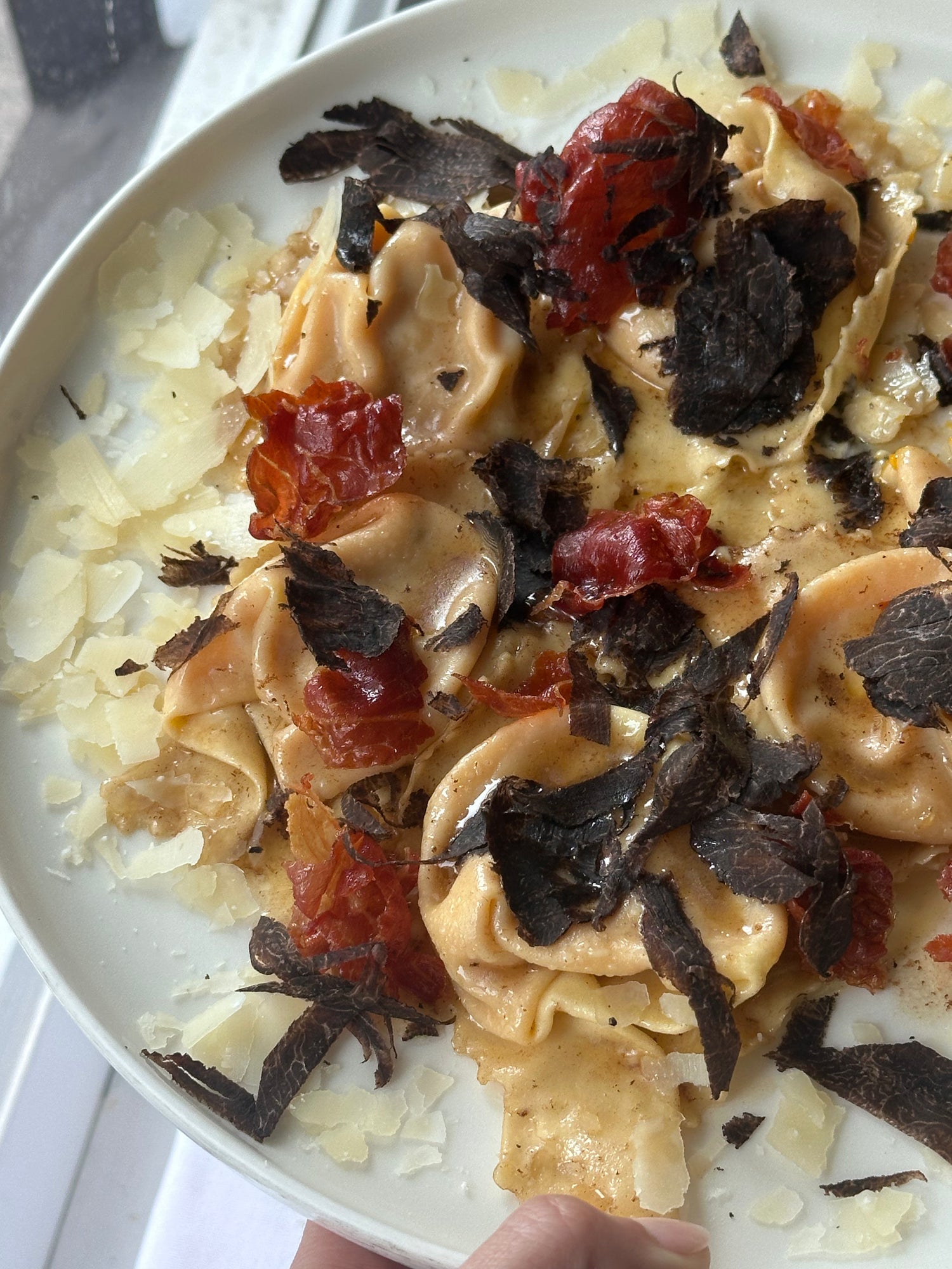 Pumpkin ravioli, leek puree, parma prosciutto, kale, parmigiano