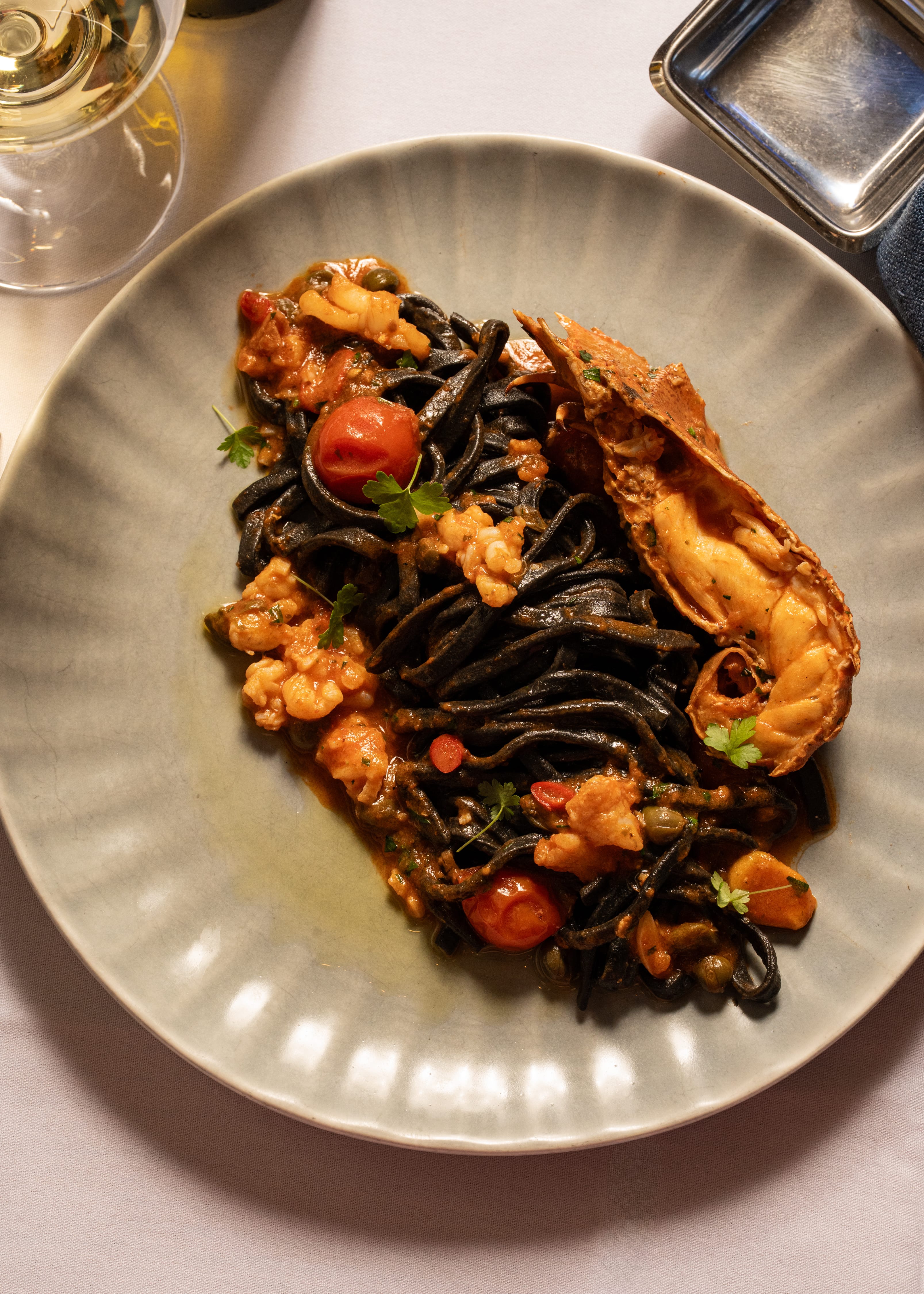 Black squid Tagliolini with Moreton bay bugs, chilli, garlic, cherry tomato, parsley