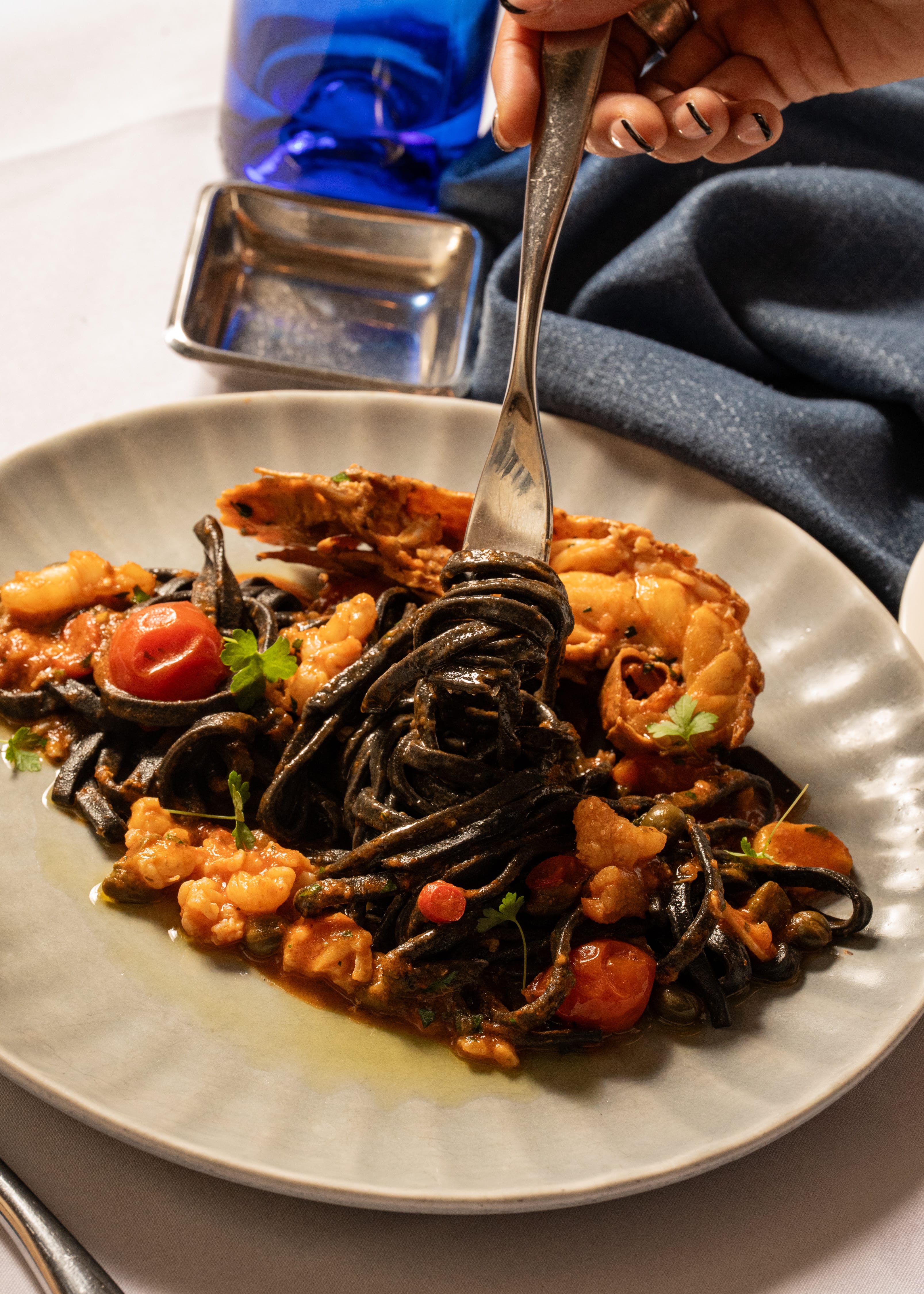 Black squid Tagliolini with Moreton bay bugs, chilli, garlic, cherry tomato, parsley